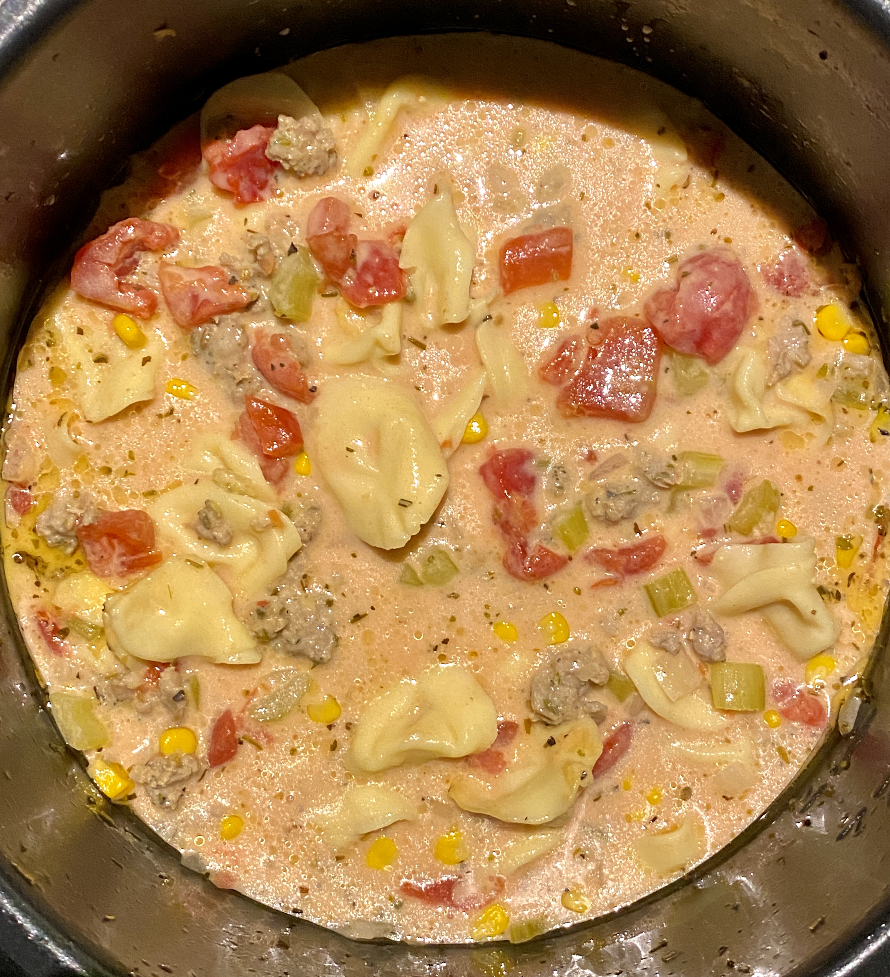 Sausage and tortellini soup in pot