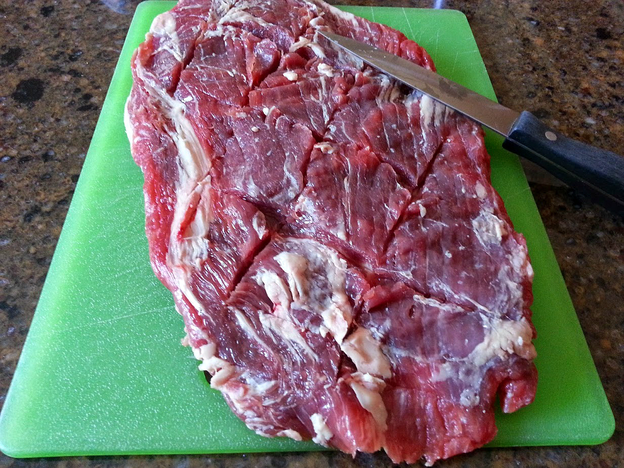 Scoring meat- flank steak stuffed with rice prep